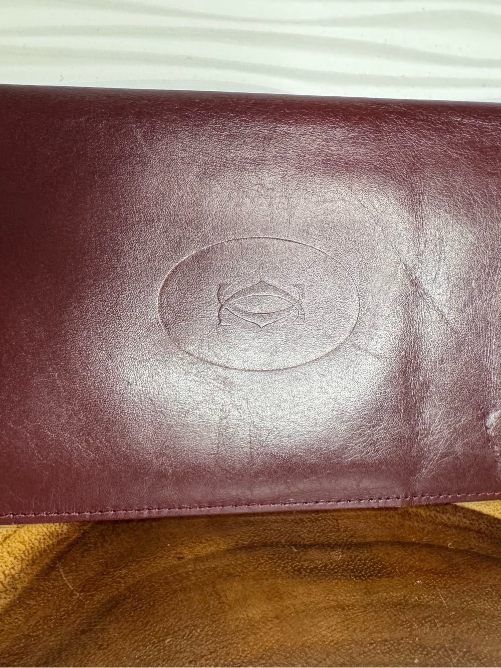Cartier ‘ Must Be Cartier’ long Wallet in Deep Burgundy with Embossed Logo
